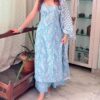 a woman in a light blue kurta set with a white floral pattern and a gathered top