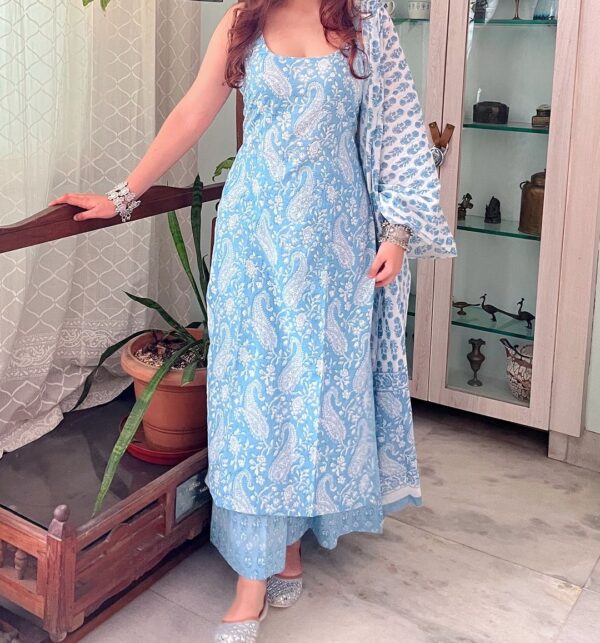 a woman in a light blue kurta set with a white floral pattern and a gathered top